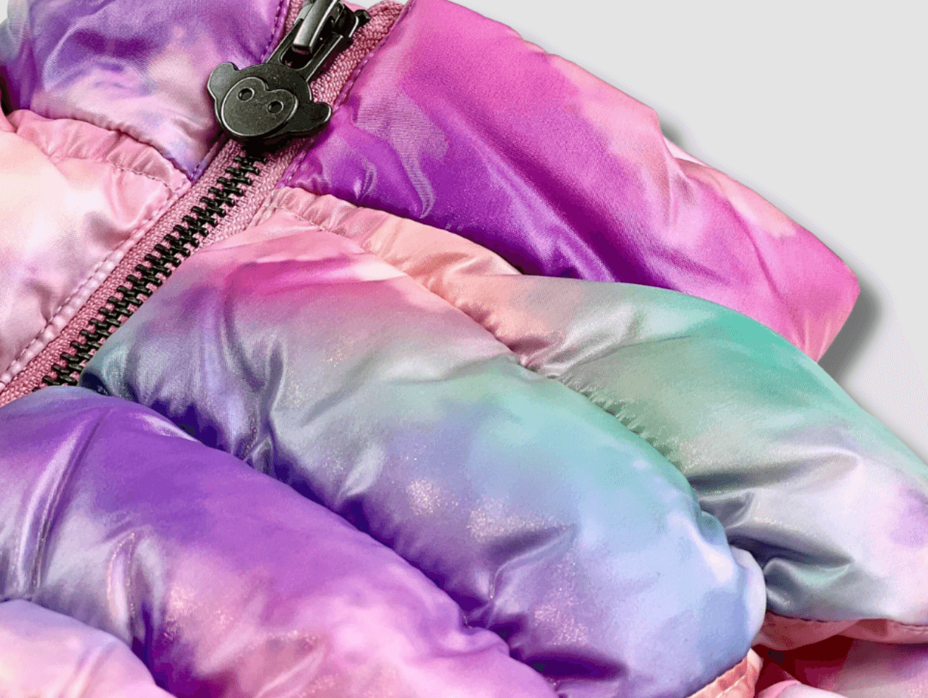 Vibrant tie-dye puffer jacket detail, perfect for stylish kids' winter adventures.