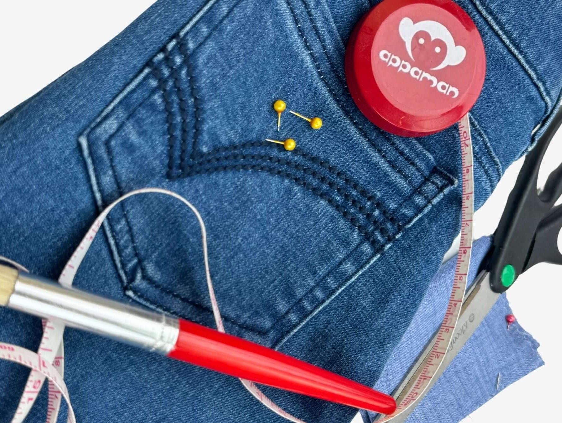 Crafting stylish hand-me-downs with denim and sewing tools for creative kids' outfit transformations.