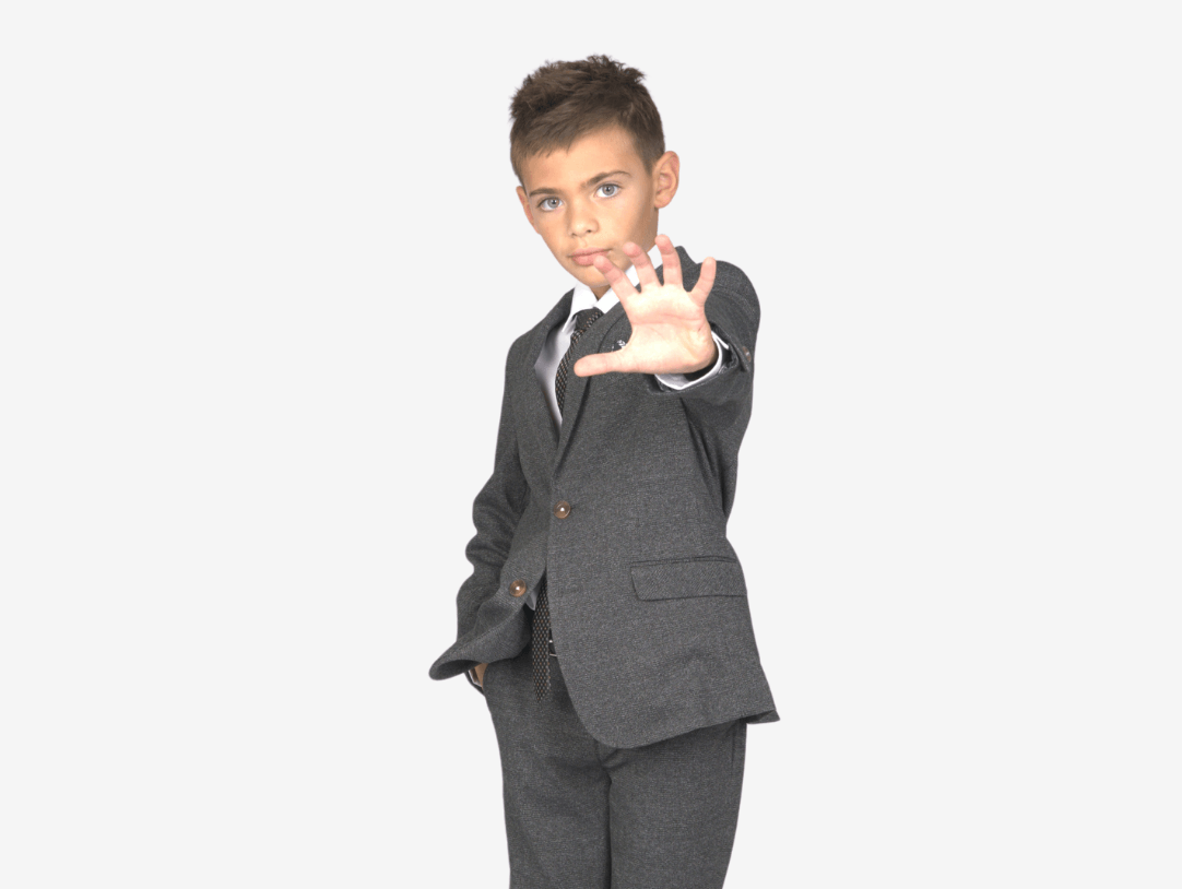 Stylish boy in a tailored suit, exuding confidence and flair for kids' formal wear.