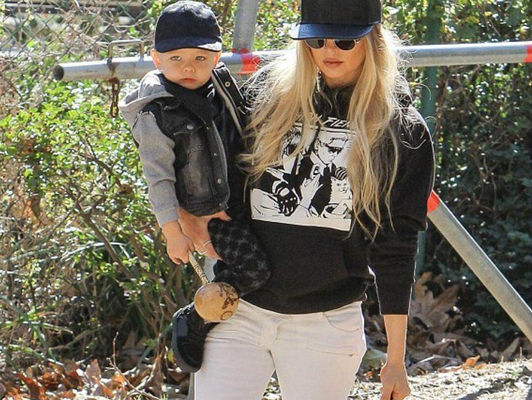 Fergie stylishly walks with Axl, sporting an Appaman jacket, showcasing playful parent tips for kids' styling.