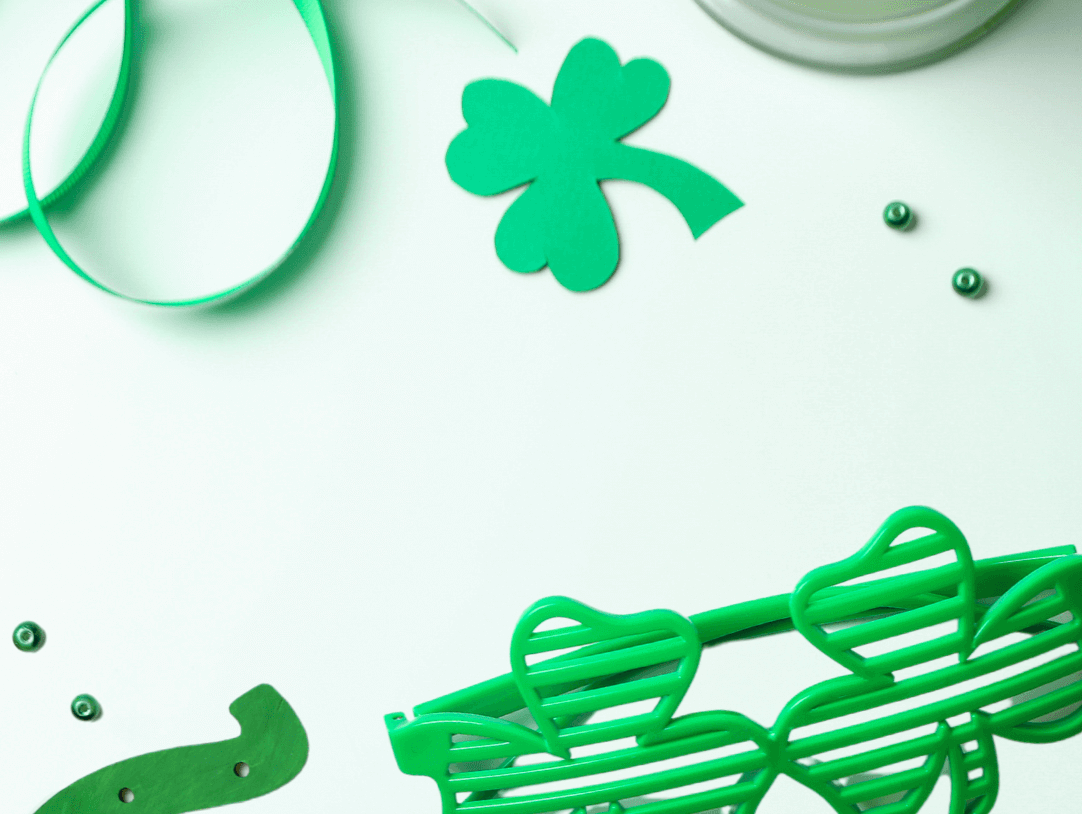 Vibrant St. Patrick's Day decor with green hat, shamrock, gift, and fun accessories for kids' celebrations.
