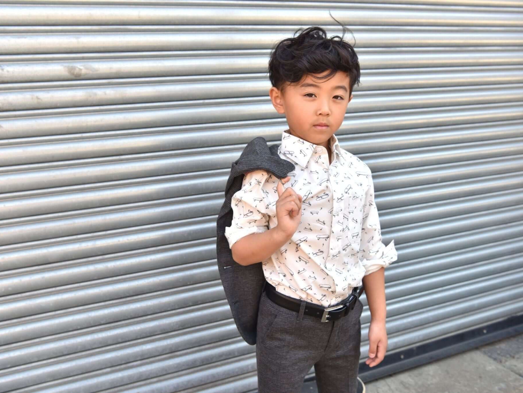 Stylish boy in a patterned shirt and blazer, ready to shine on Sunday mornings with Appaman's chic boys' clothing.