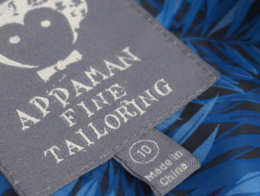 Appaman's stylish label showcasing fine tailoring details and vibrant blue lining in a kids' linen suit.