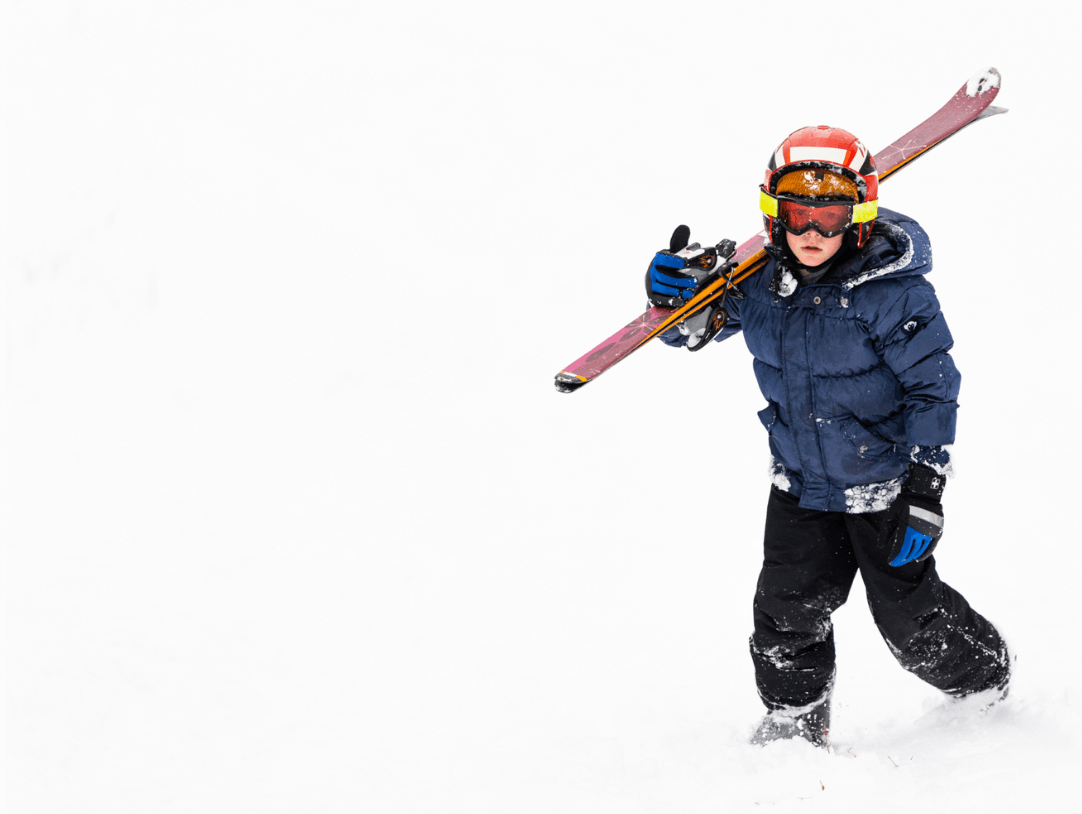 Excited kid in stylish ski gear, ready to hit the slopes with confidence and flair!