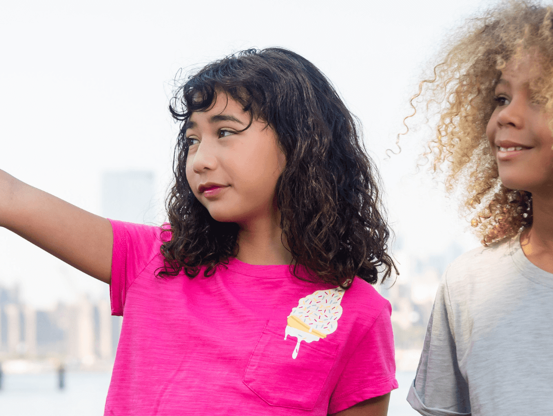 Two kids enjoying summer in stylish ice cream-themed tees, the perfect blend of fun and fashion for trendy children's outfits.