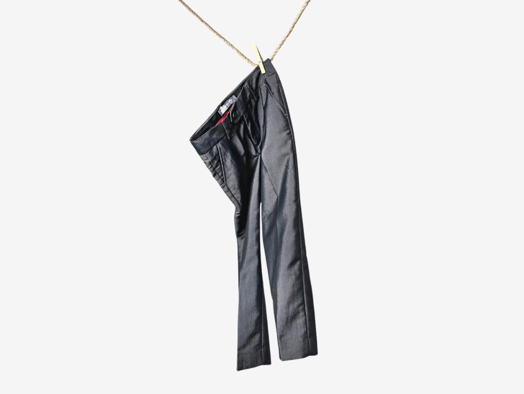 Stylish black kids' pants hanging playfully, ideal for trendy boys' outfits and versatile kids styling tips.