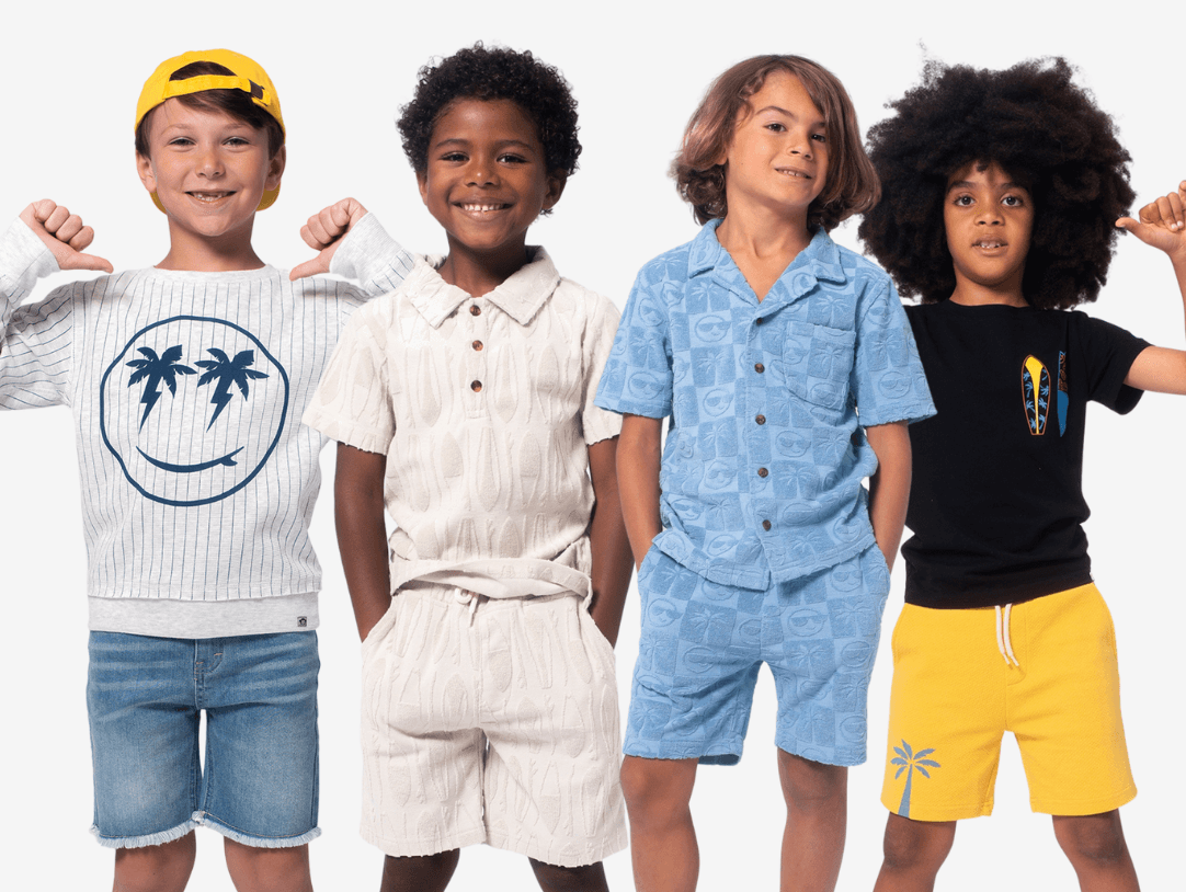 Four stylish boys showcasing trendy summer outfits, radiating confidence and fun in their playful looks.