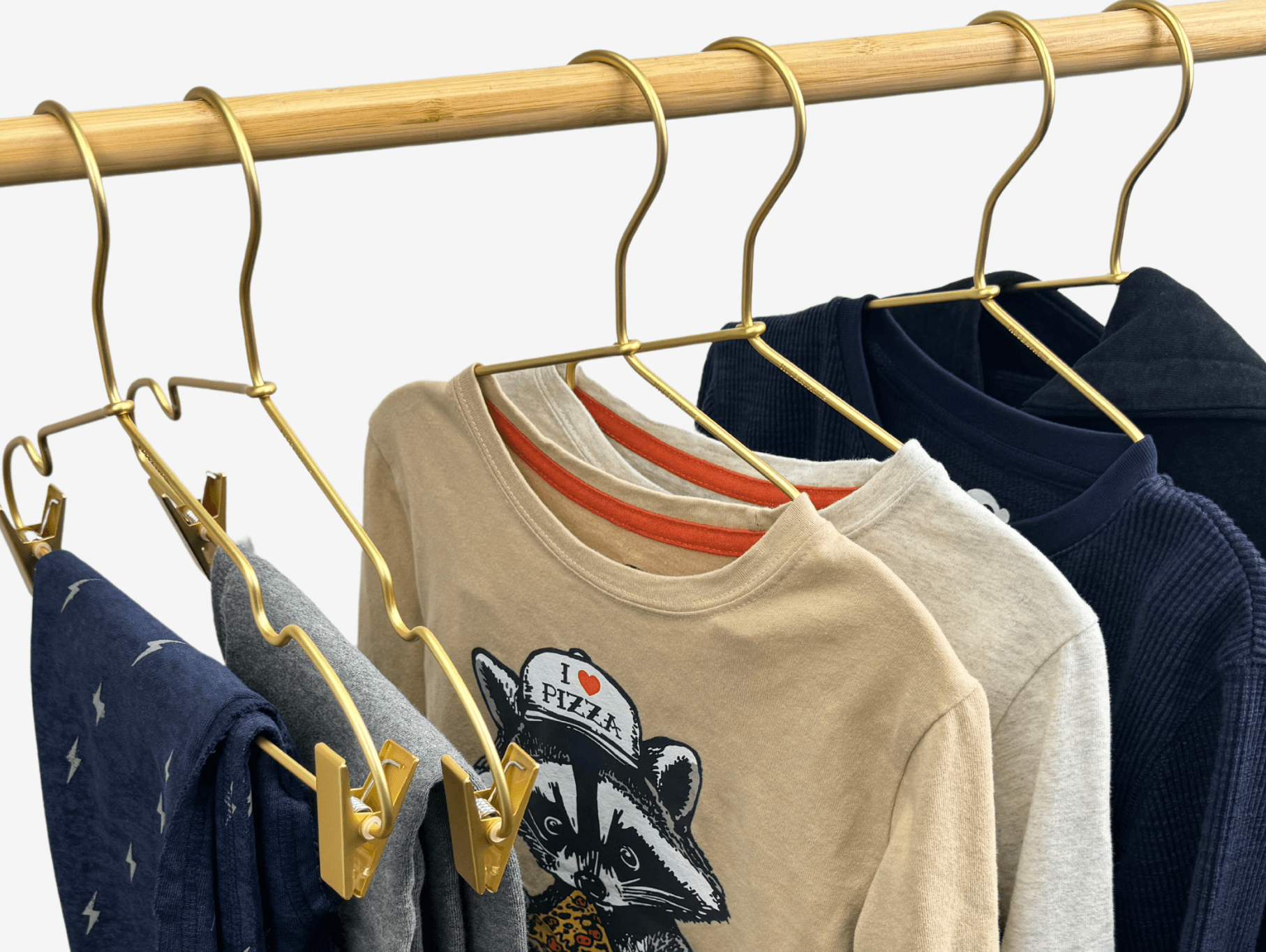 Stylish kids' shirts hanging on gold hooks, perfect for parent tips on kids' fashion and effortless styling.