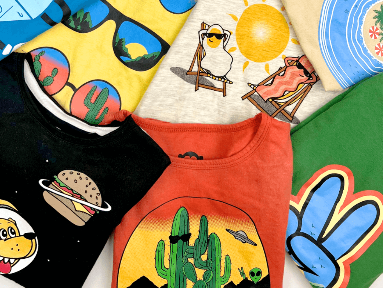 Colorful kids' graphic tees featuring fun designs like burgers, sunglasses, and cacti—perfect for stylish summer adventures!