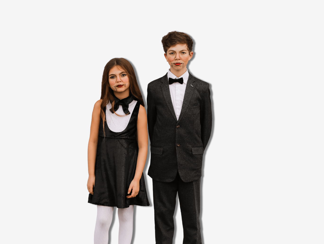 Stylish kids in chic black costumes, showcasing modern Halloween looks for boys and girls. Perfect for last-minute ideas!