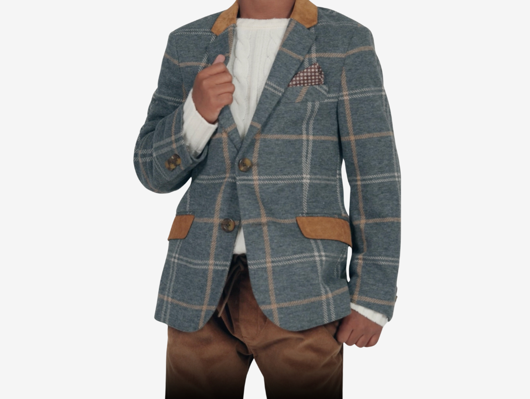 Stylish boy in a checked suit jacket, effortlessly blending casual and chic for a trendy look.