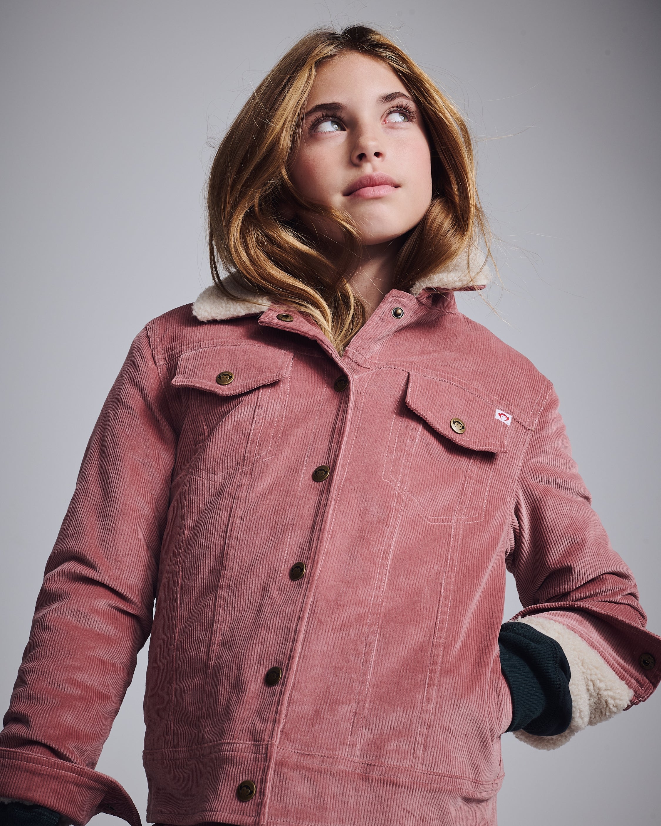 Girl wearing a stylish pink corduroy jacket from the Girls' Jackets & Vests collection.