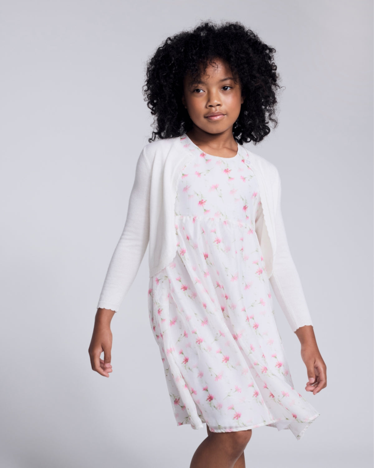 Girls' Dresses & Rompers: A young girl in a denim dress with pink tights, exuding joy and style.