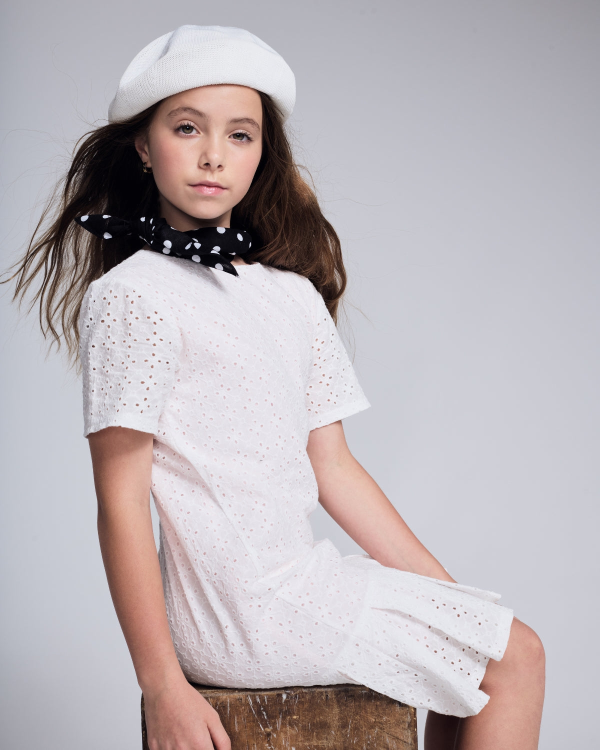 A young girl wearing a pink corduroy jacket, skirt, and brown boots, showcasing Girls' New Arrivals.