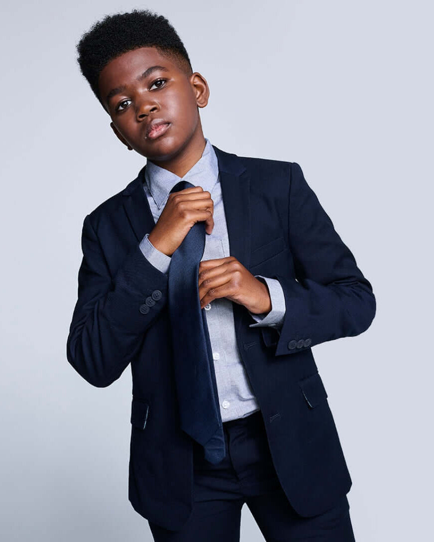 Boys' Ties stylishly complementing a little boy's suit in smart attire.