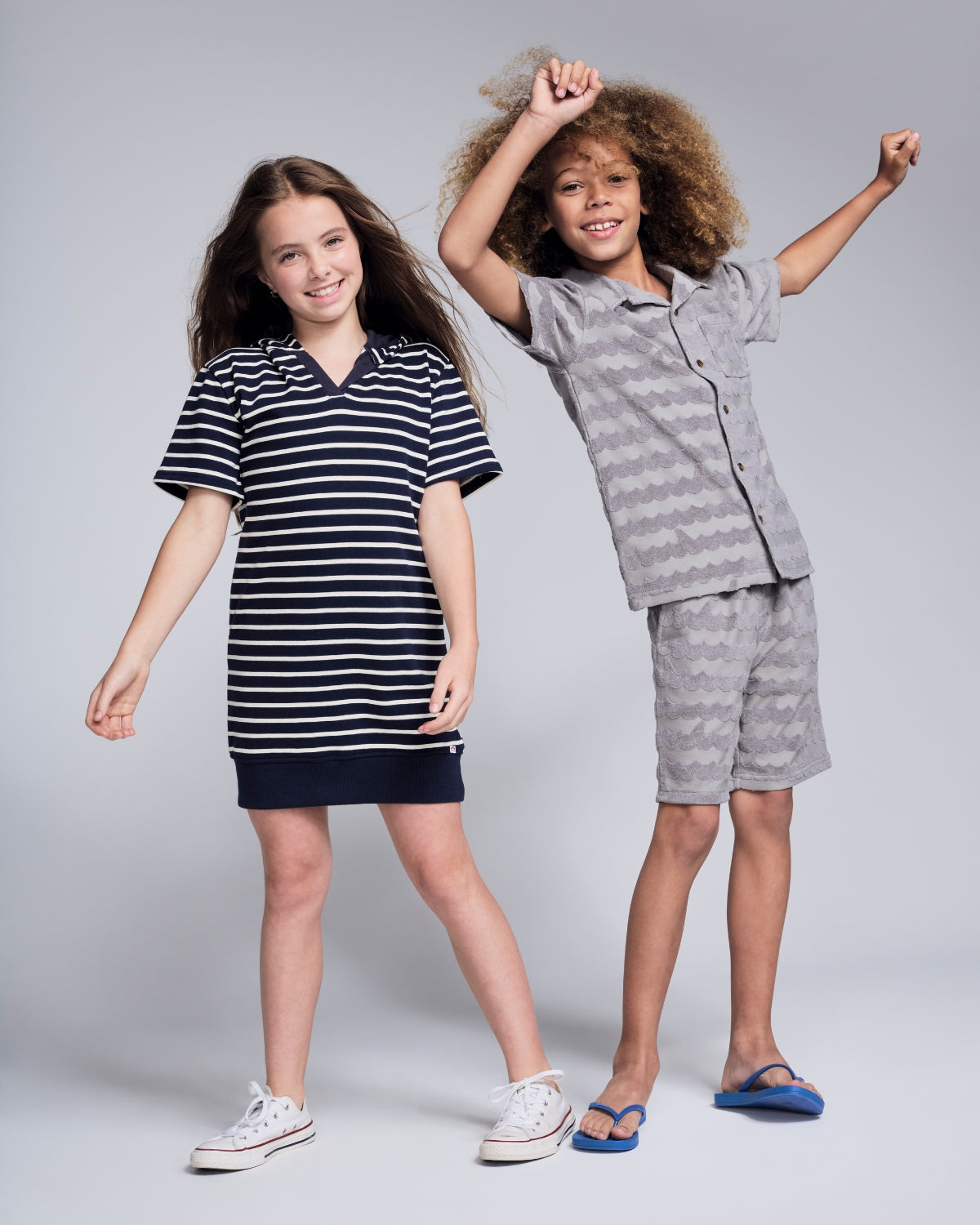 Kids Terry Cloth Cover Ups showcased by two children in colorful outfits, emphasizing fun and summer vibes.