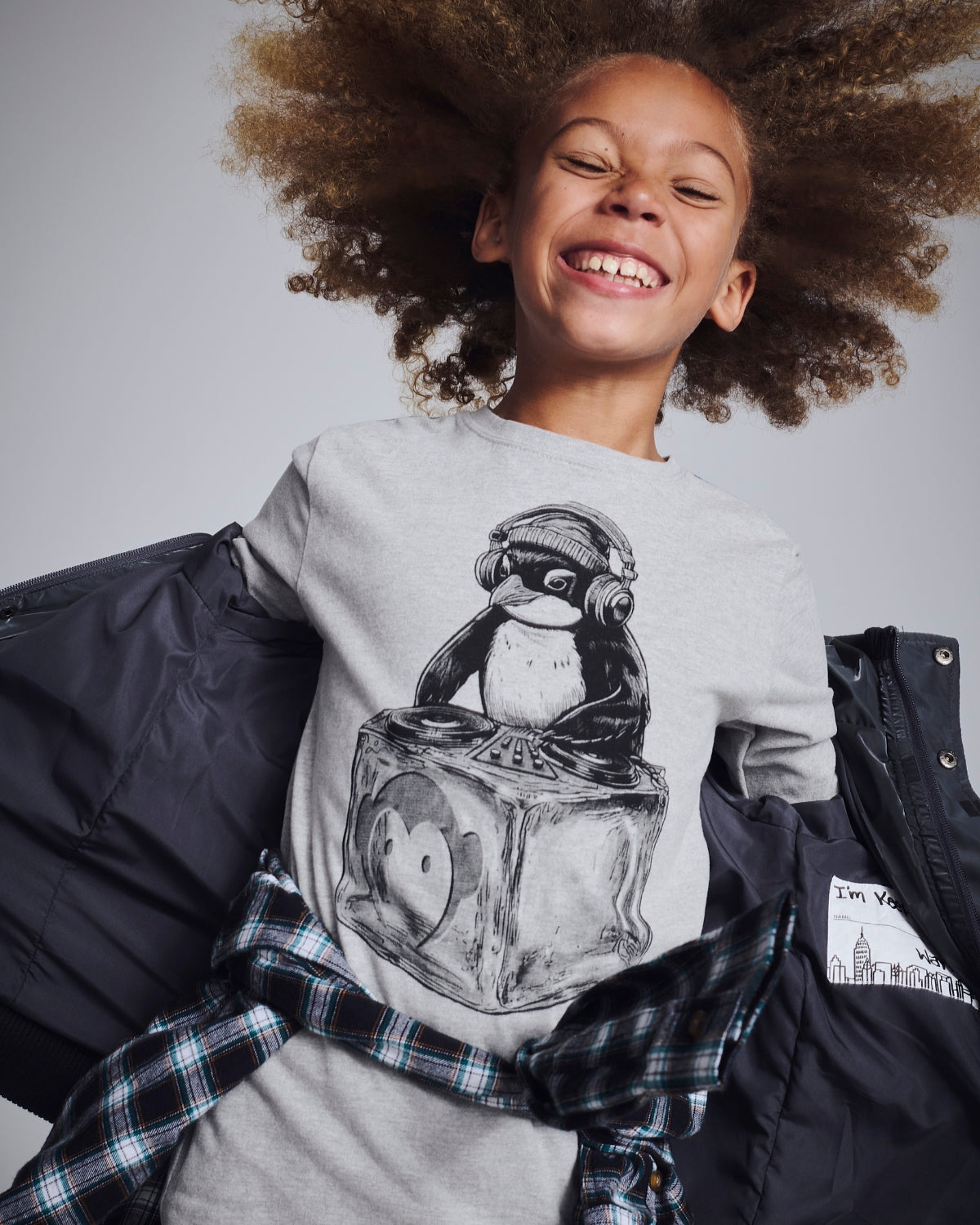 Boy sporting a playful pretzel graphic tee, showing off his confident style and fun personality.