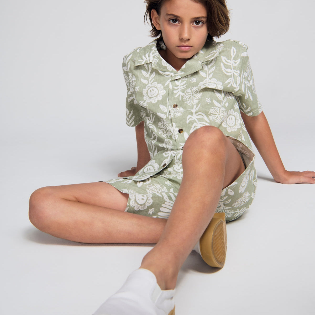Boys' Clothing collection featuring a young boy in a yellow long-sleeve shirt surrounded by autumn leaves.