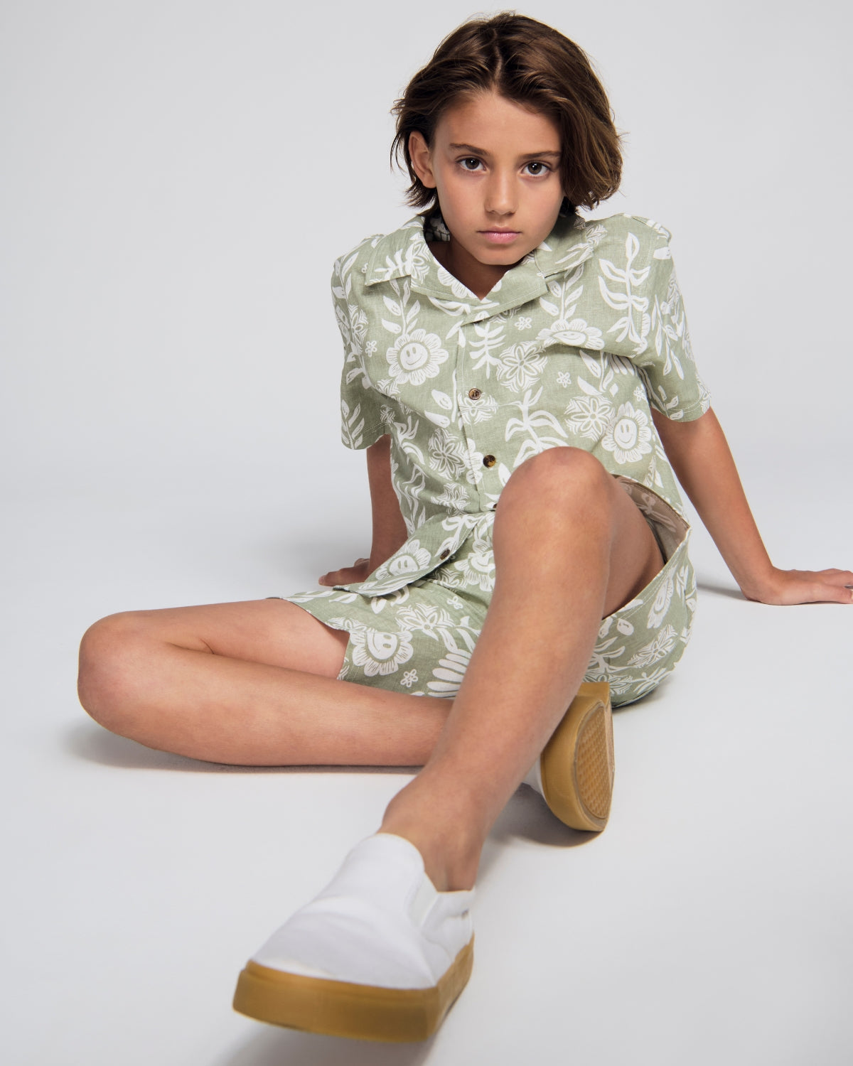 Boys' Clothing collection featuring a young boy in a yellow long-sleeve shirt surrounded by autumn leaves.
