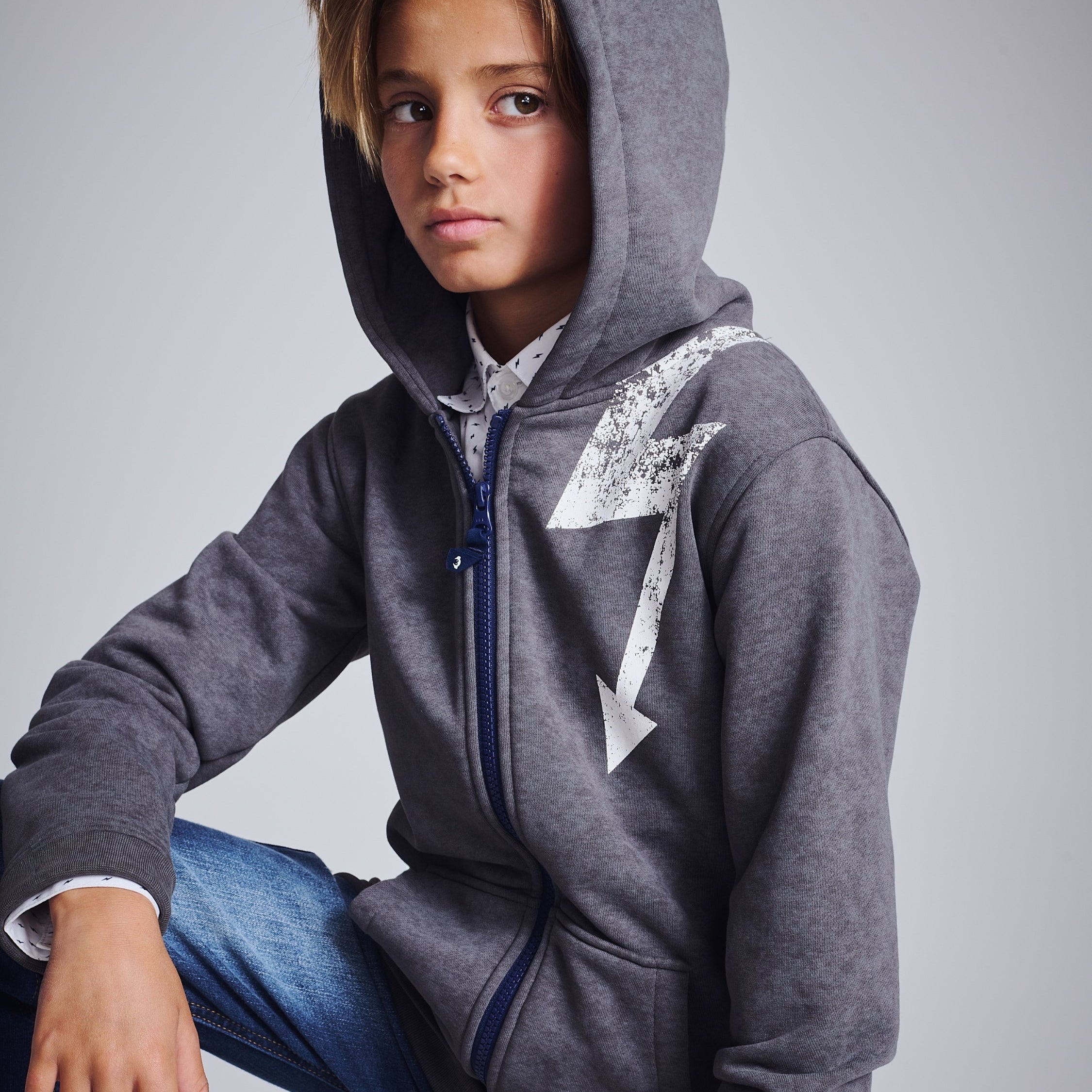 A cheerful boy showcasing a trendy tie-dye hoodie, blending comfort and style for the modern kid.