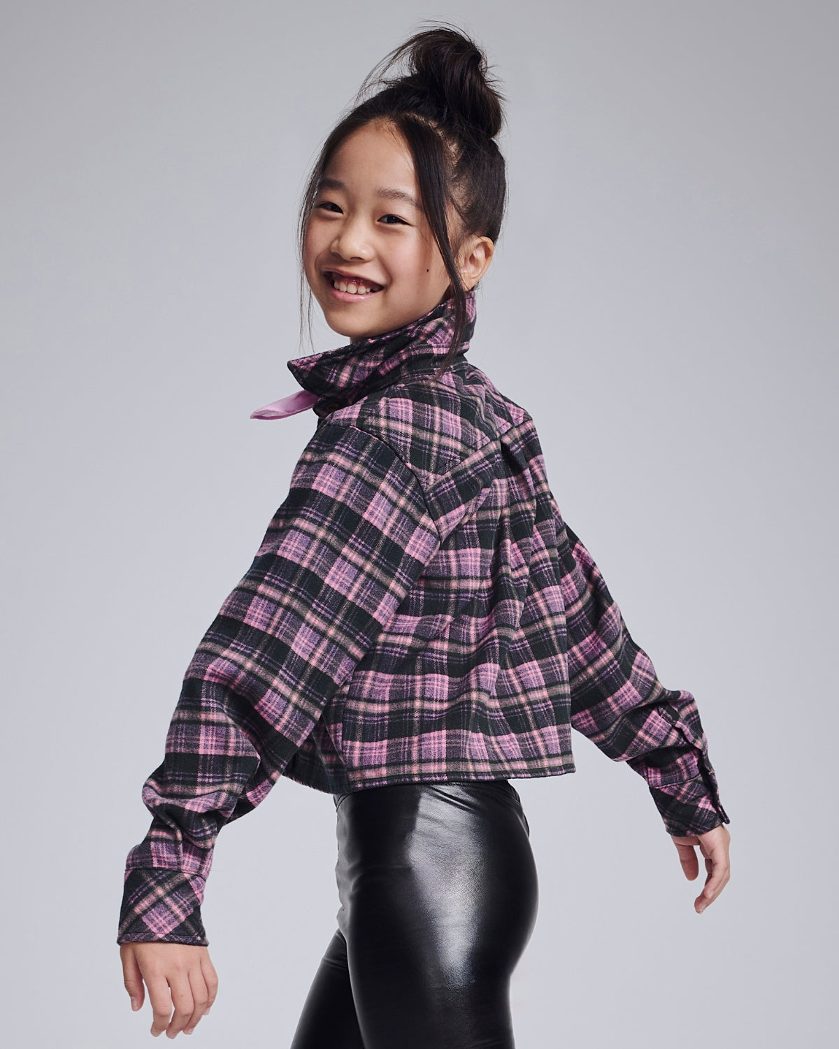 Stylish girl in a playful dog graphic tee and denim shorts, bringing fun to kids clothing with personality!