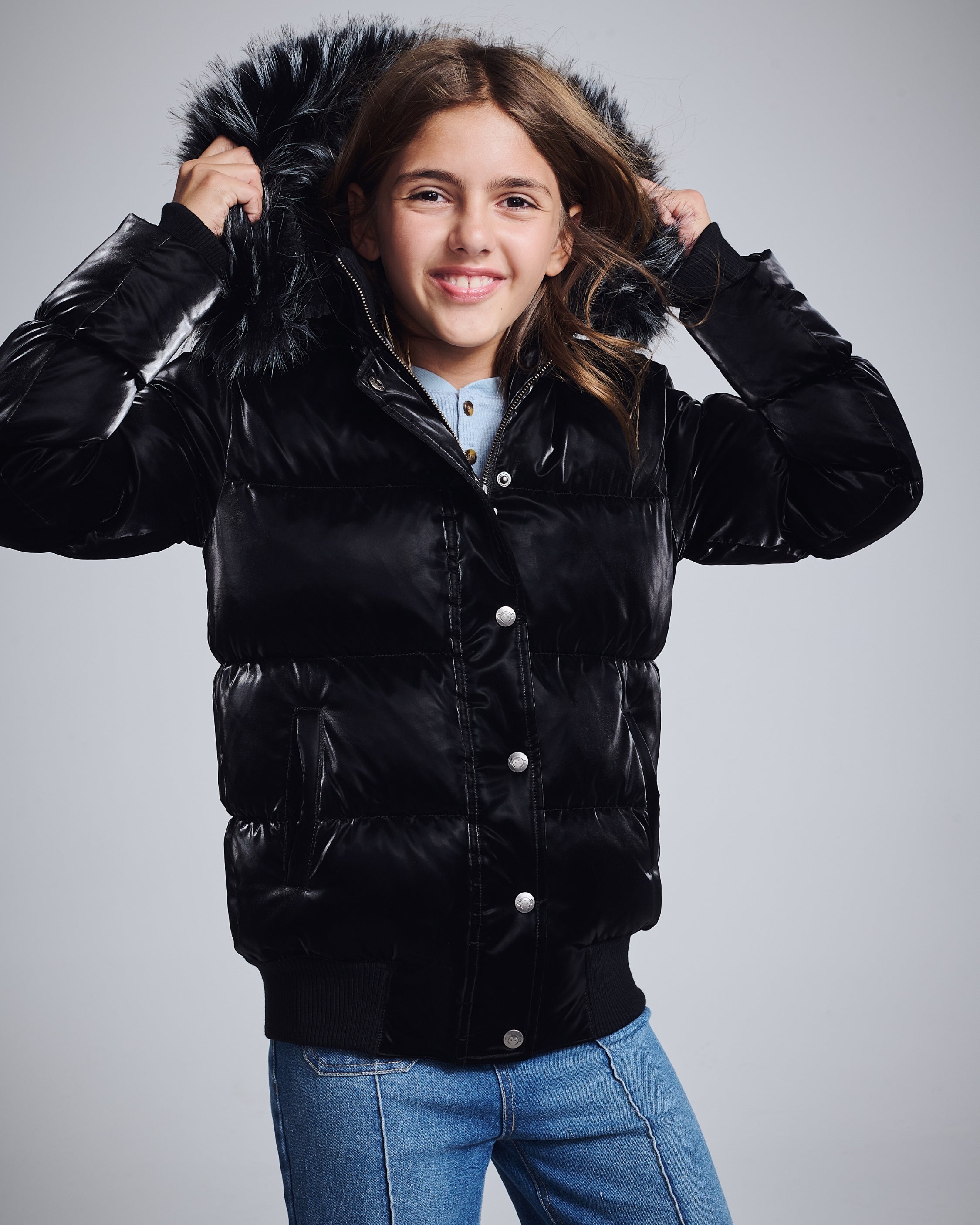 Stylish girl in a chic metallic puffer jacket, ready to conquer winter in comfort and style!