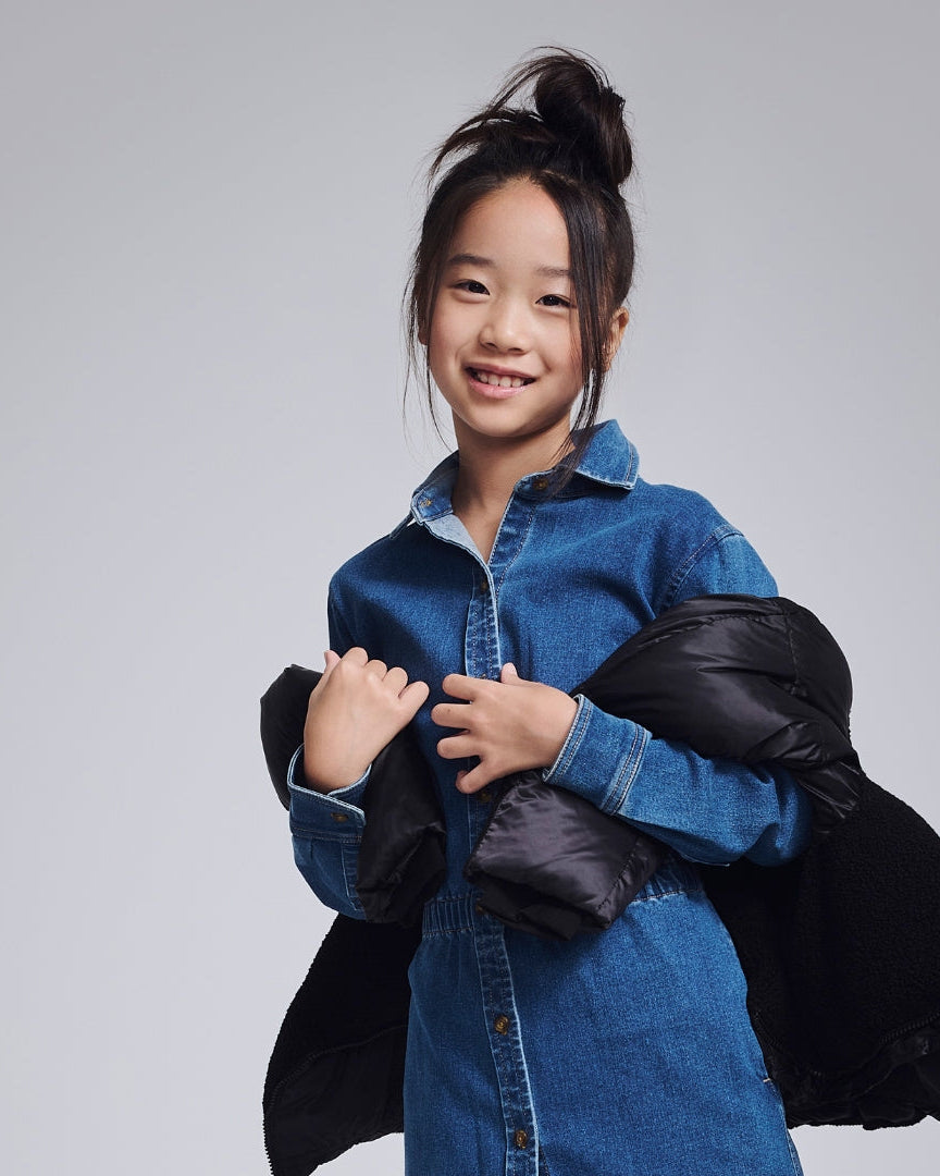 Cheerful girl in a vibrant yellow floral dress, perfect for sunny days and back-to-school adventures!