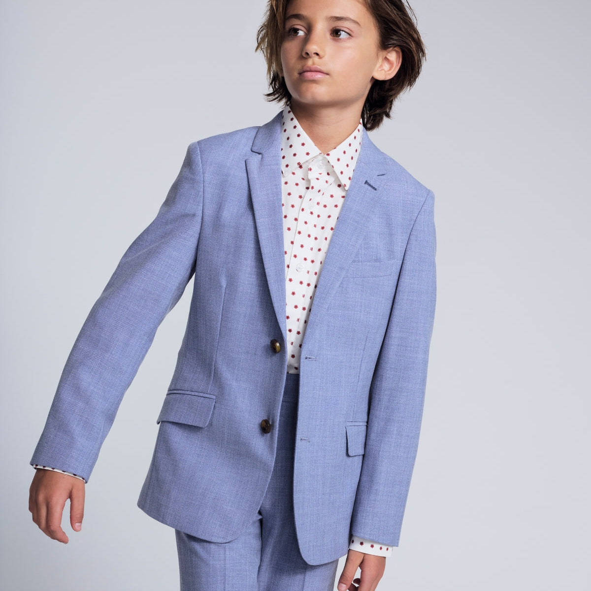 Boys' Dress Clothes collection featuring a young boy in a stylish black suit with a tie, perfect for special occasions.