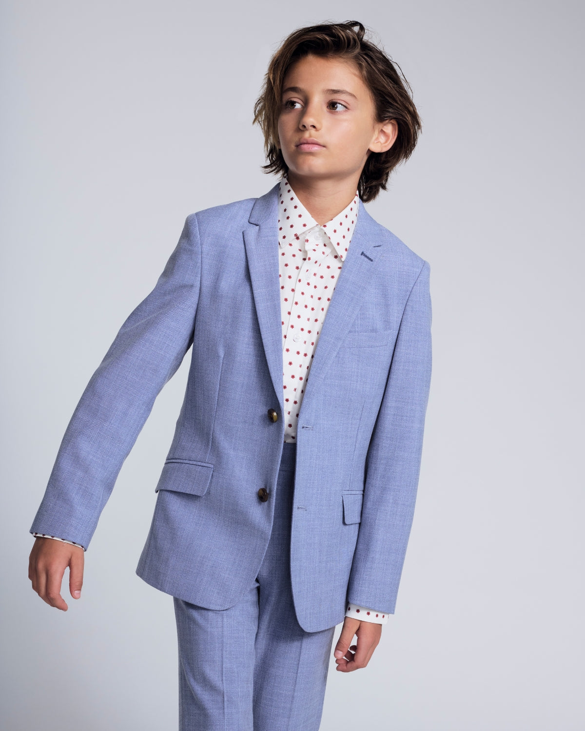 Boys' Dress Clothes collection featuring a young boy in a stylish black suit with a tie, perfect for special occasions.