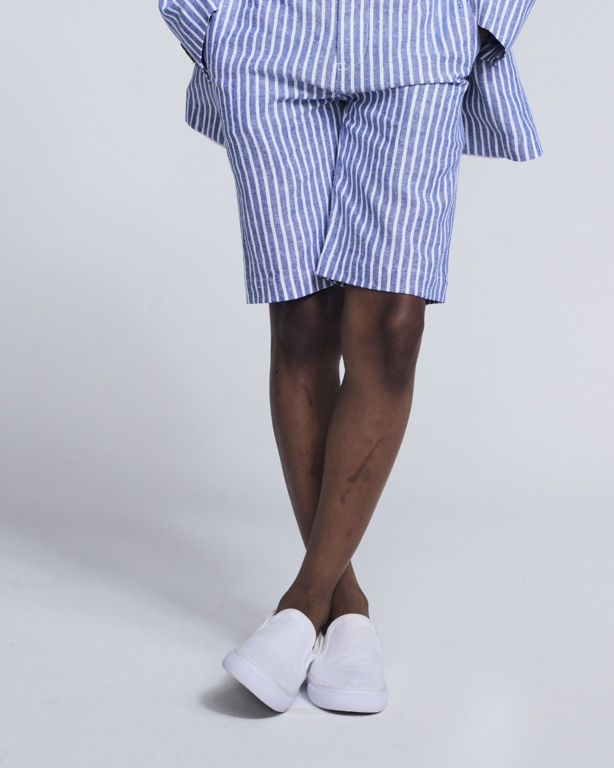 Boys' Trouser Shorts in striped pattern worn with white sneakers, perfect for summer adventures.