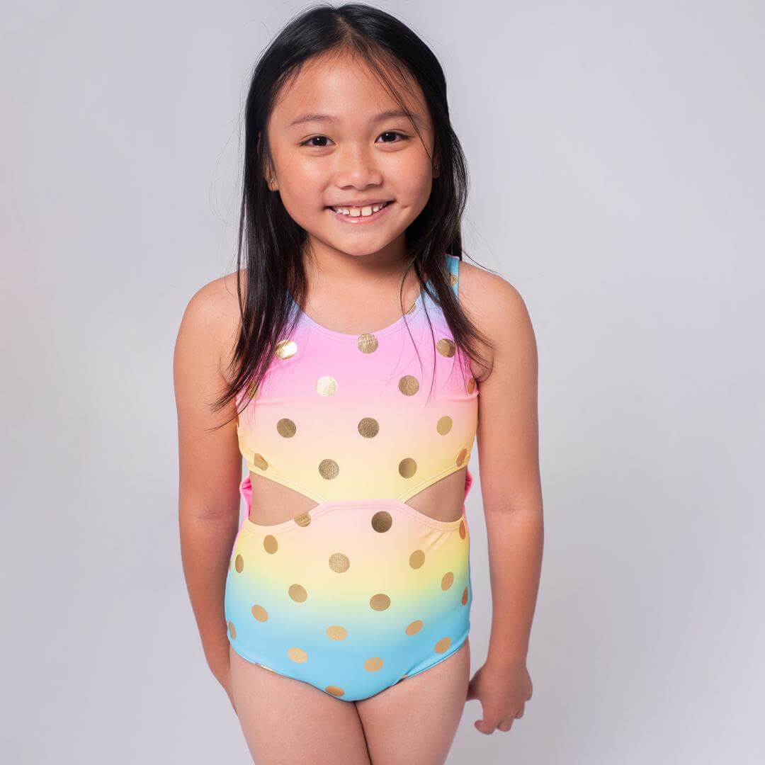 Sunny smile and colorful polka dot one-piece swimsuit for girls, blending style and comfort for playful summer days.