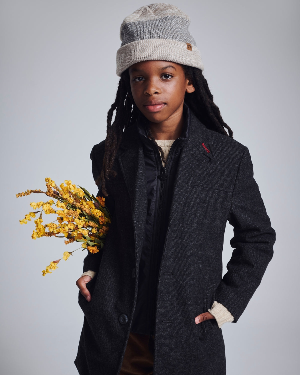 Stylish young boy in a navy City Overcoat, exuding charm and warmth for any formal occasion.