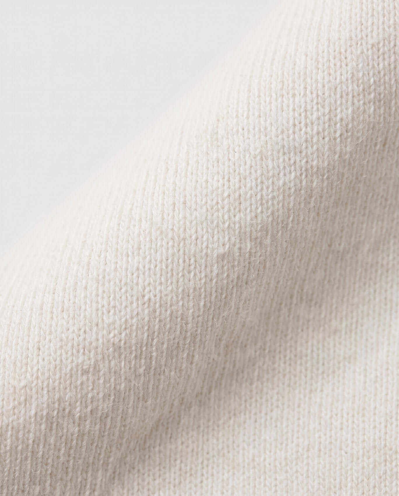 Close-up of textured beige fabric with a gradient background