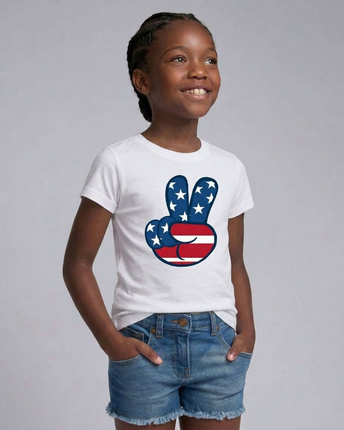 Child wearing a white t-shirt with a peace sign design featuring the American flag on a gray background
