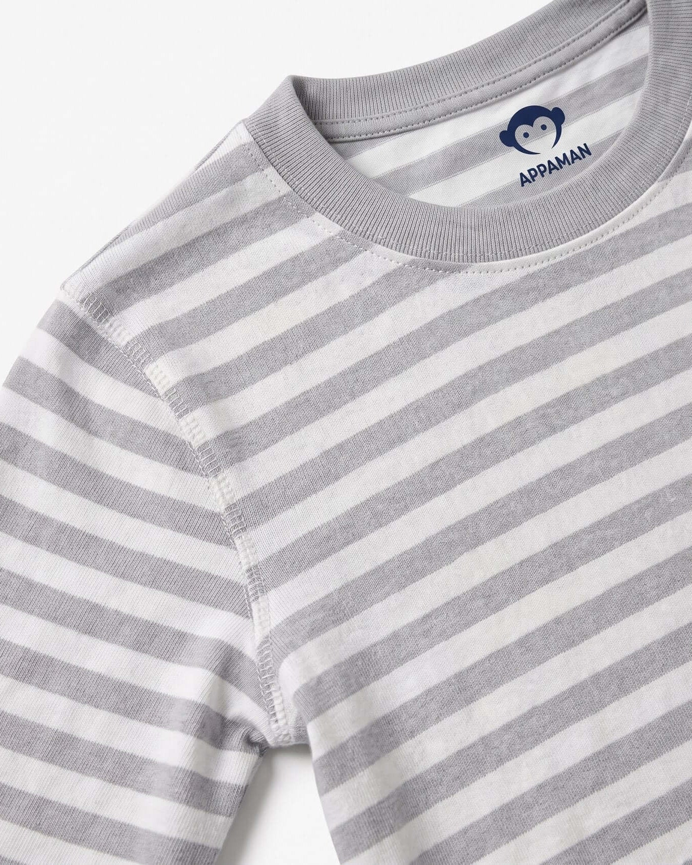 Close-up of a gray and white striped shirt with Appaman logo on a white background