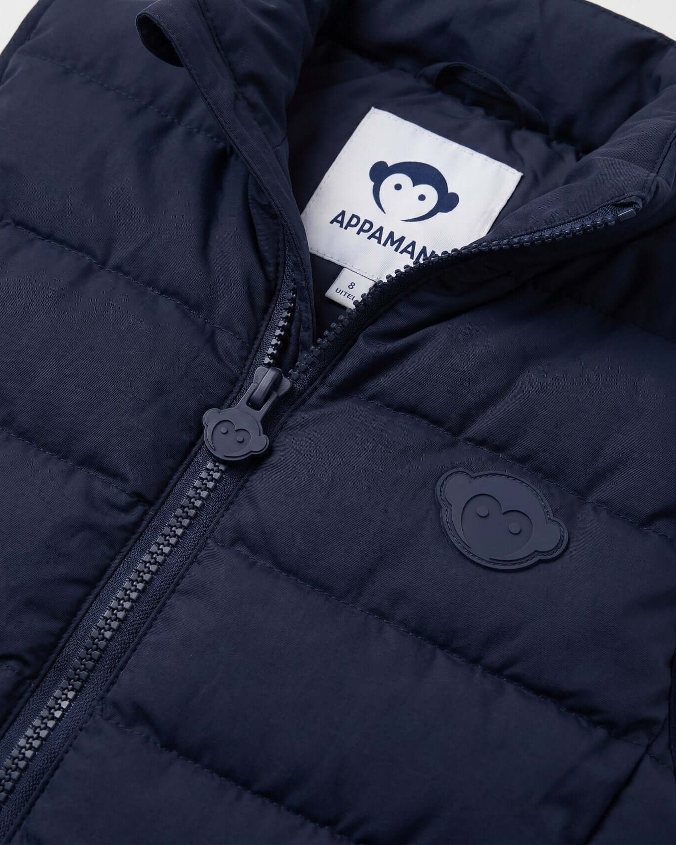 Navy blue puffer jacket with Appaman logo on a white background