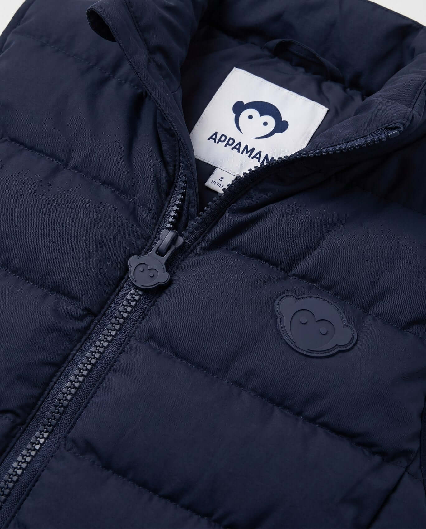 Navy blue puffer jacket with Appaman logo on a white background