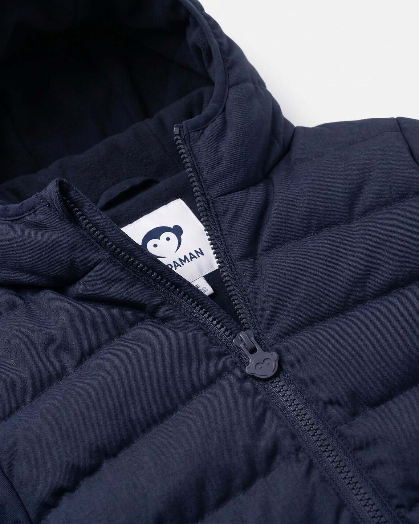 Navy blue puffer jacket with a brand logo on the zipper area against a white background