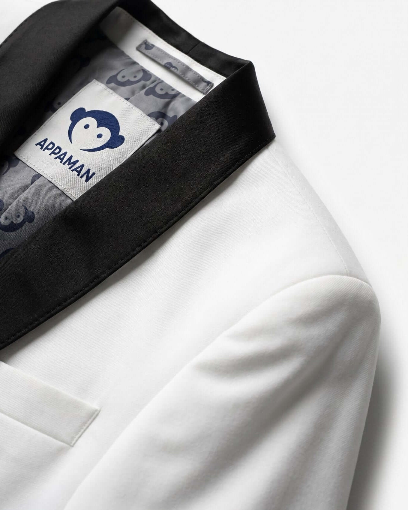 White jacket with black lapels and Appaman logo on a white background