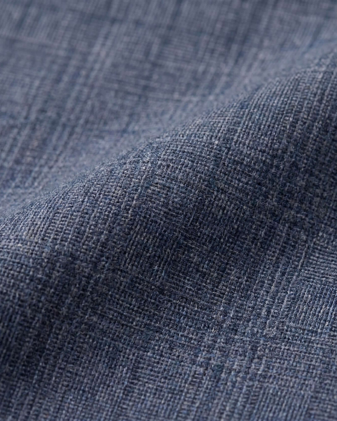 Close-up of textured blue fabric with a subtle pattern