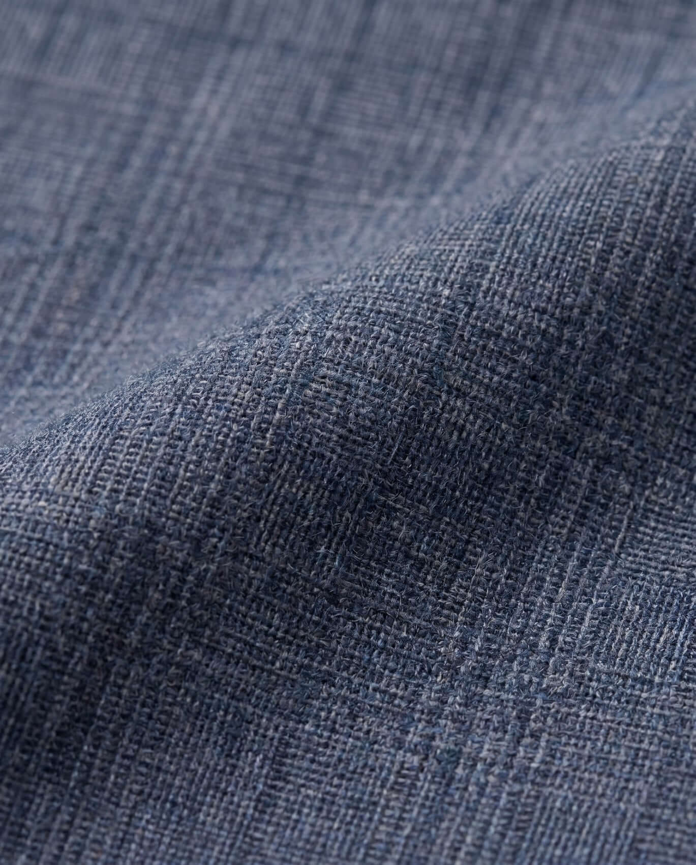 Close-up of textured blue fabric with a subtle pattern