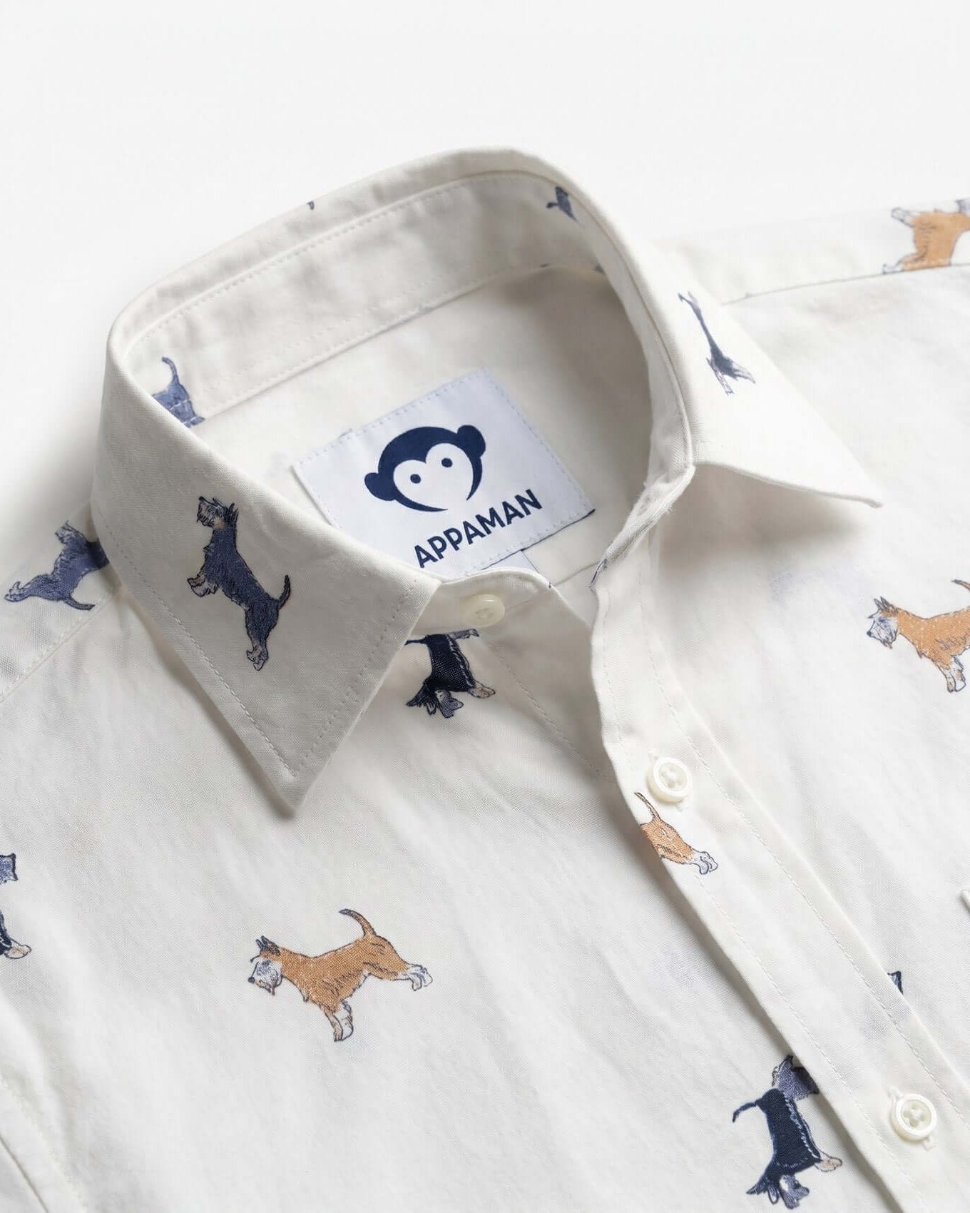 White shirt with dog pattern and Appaman label on a white background