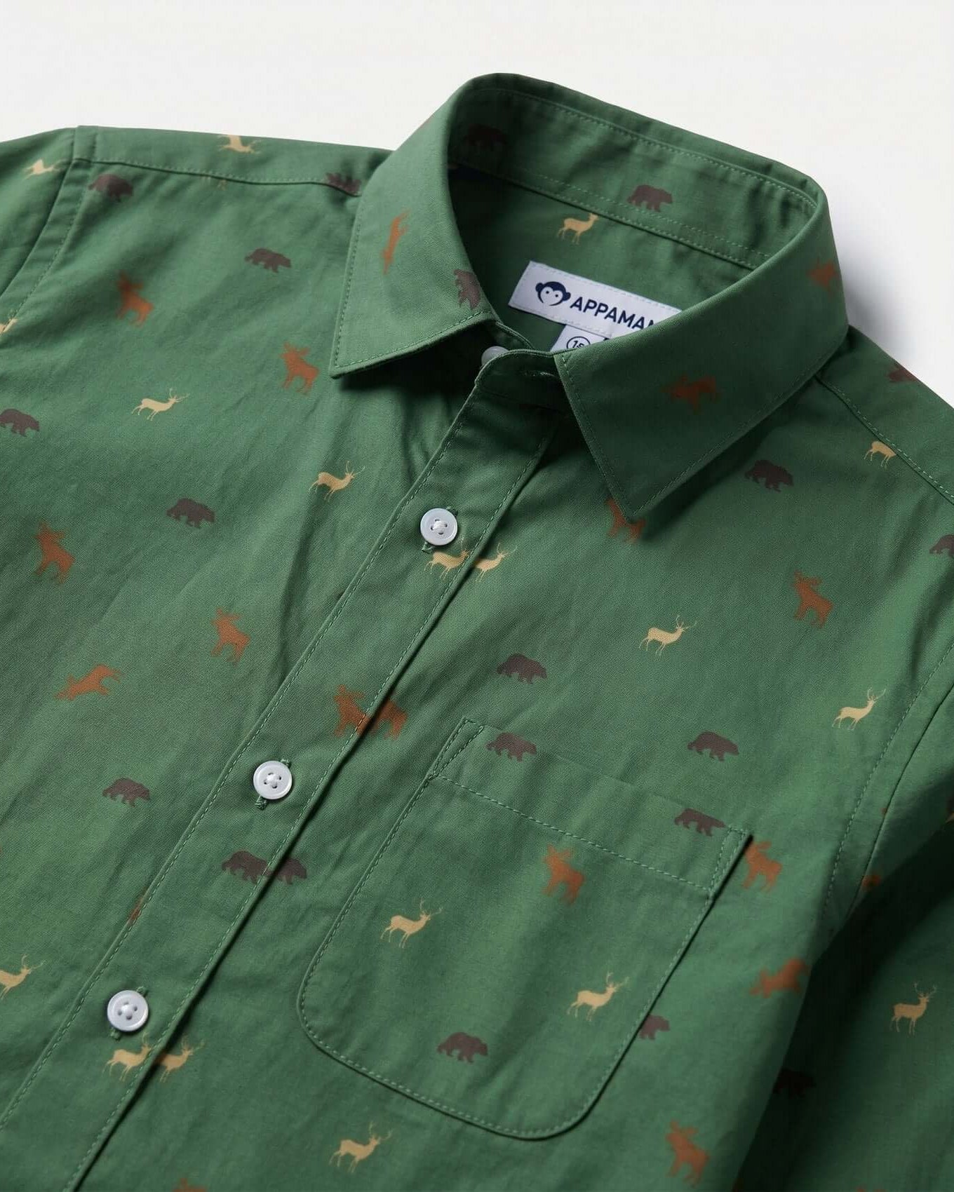 Green shirt with animal pattern and Appaman label on a white background