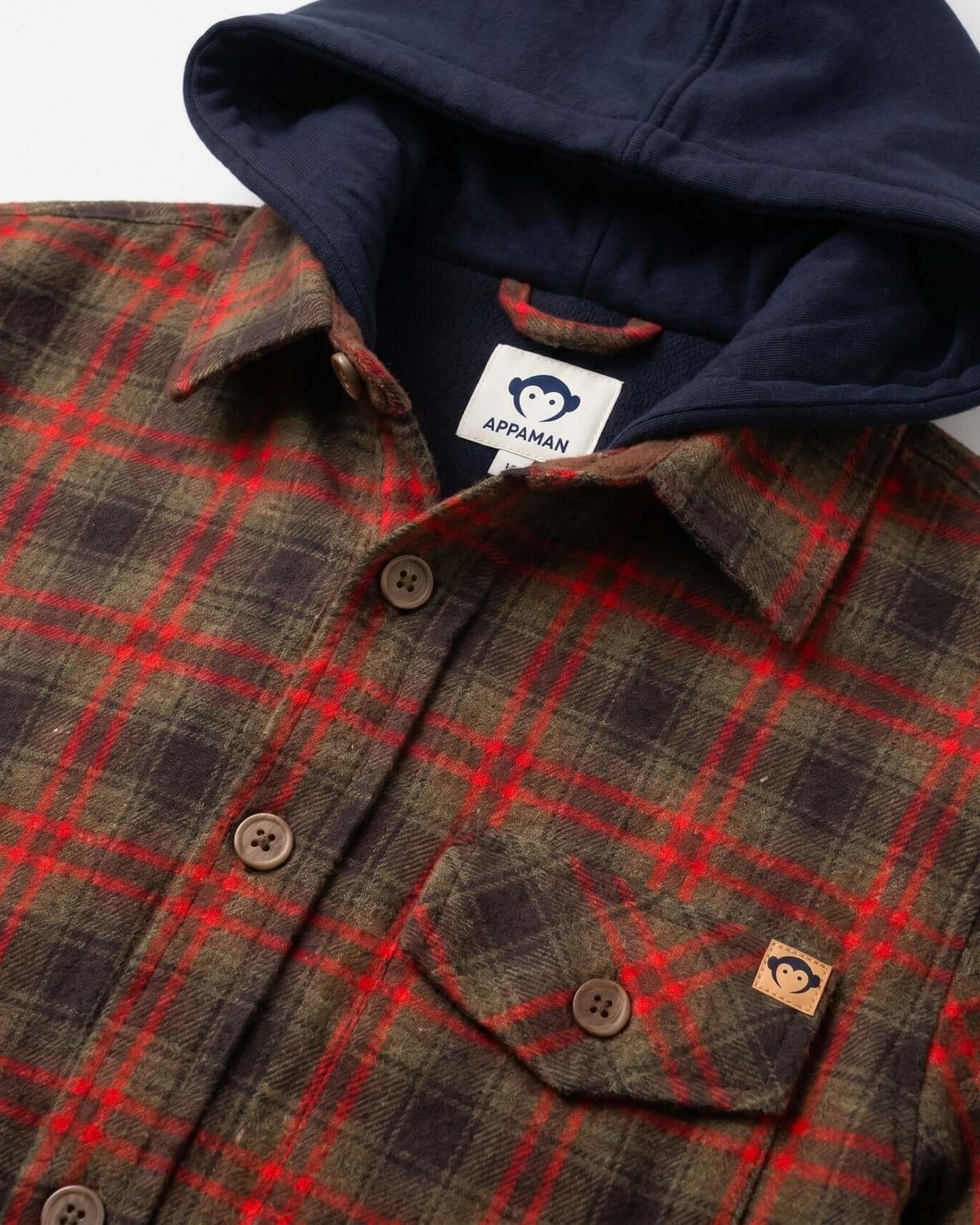 Plaid shirt with navy hoodie on a white background, featuring Appaman logo.