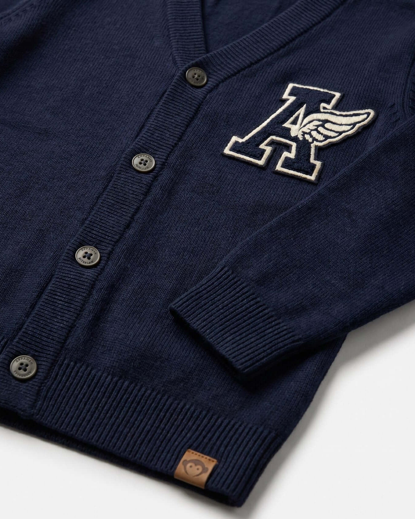 Navy blue cardigan with a logo on a white background