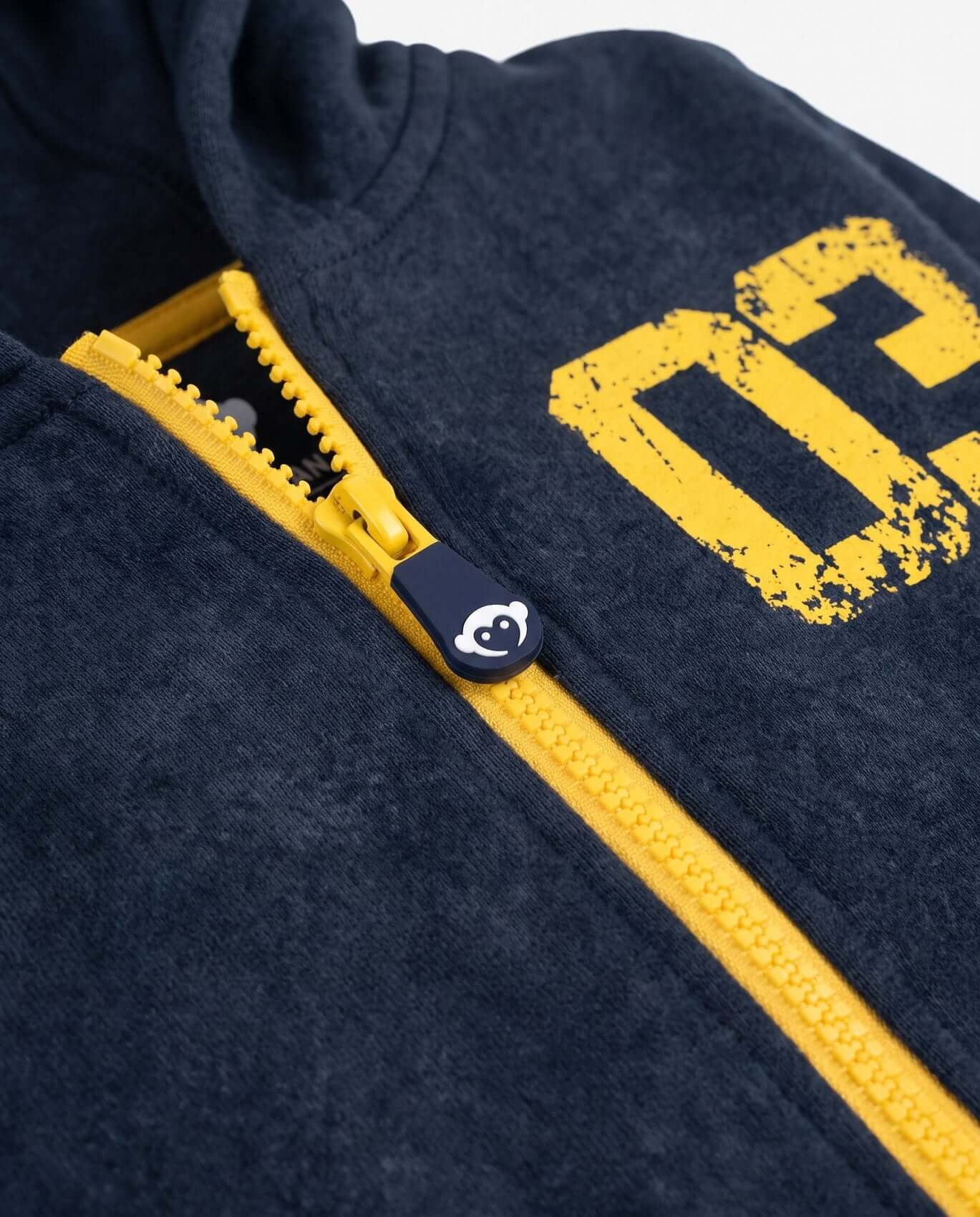 Navy blue hoodie with yellow zipper and logo on a white background