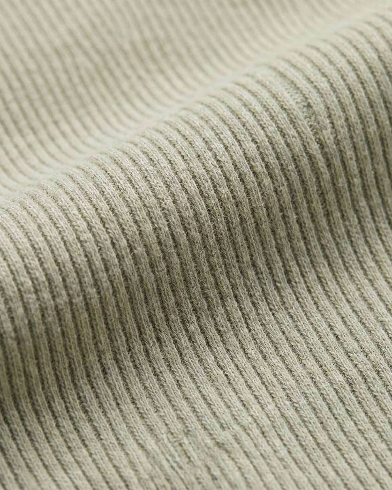 Close-up of ribbed fabric texture in a neutral color