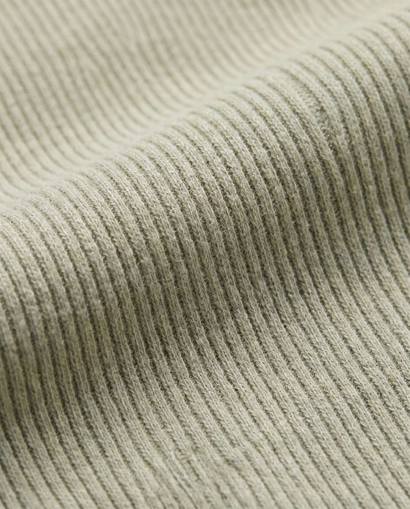 Close-up of ribbed fabric texture in a neutral color