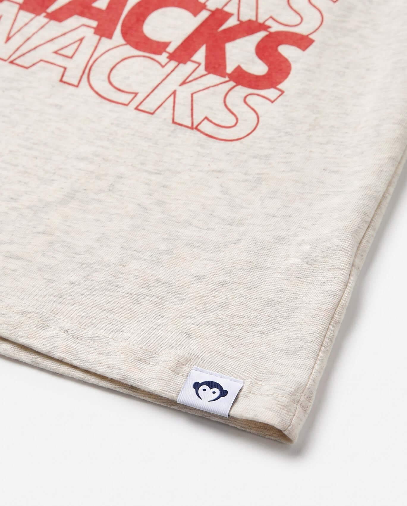 Beige fabric with red text 'SNACKS SNACKS' and a brand logo on a white background