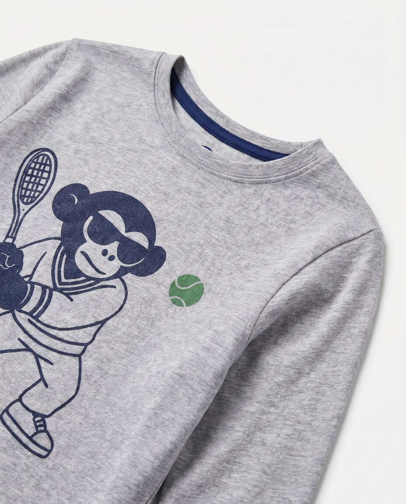 Gray sweatshirt with a graphic of a person playing tennis on a white background